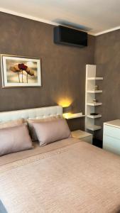 a bedroom with a large bed with a white headboard at Giulia By The Sea in Follonica