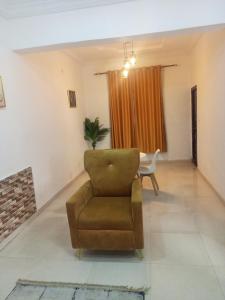 a living room with a chair and a table at AG Sigma Apartments in Port Harcourt