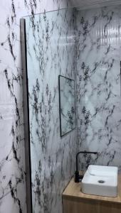 a bathroom with a sink and a mirror at AG Sigma Apartments in Port Harcourt