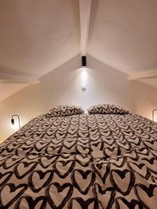a bedroom with a large bed with hearts on it at Beatrice's gardens in Nivelles +14 photos