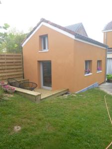 a house with a deck and a yard at Beatrice's gardens in Nivelles