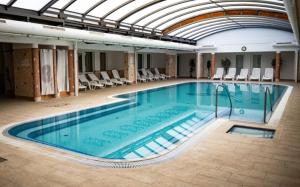 a large swimming pool with chairs in a building at Mnd Aqua Nest in Zalakaros