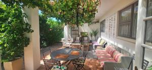 an outdoor patio with a table and chairs at The Lily House Hermanus - Central Private Cottages in Hermanus