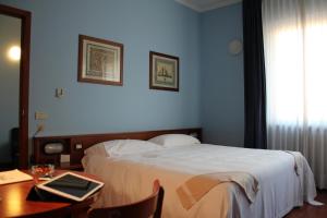 Postel nebo postele na pokoji v ubytování Hotel Mariani