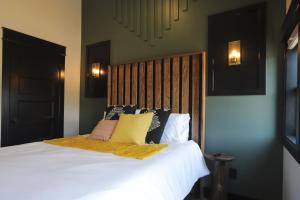 a bedroom with a bed with white sheets and pillows at Chic Queen Apartment At The Victorian Unit A in Muskegon