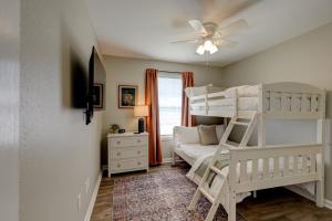 a bedroom with bunk beds and a ceiling fan at Mimosa Getaway - Thomasville Fun! in Thomasville