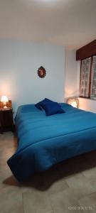 a large blue bed in a bedroom with two lamps at Casa GALLI Como in Colverde