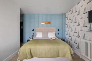 a bedroom with a large bed and blue walls at Leader Suite - Sea View - Free Wi-Fi in Brixham