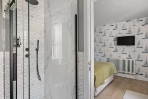 a bathroom with a shower and a bed and a television at Leader Suite - Sea View - Free Wi-Fi in Brixham