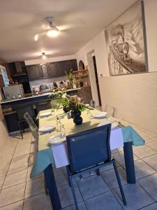 a dining room with a table and chairs in a kitchen at Tortue marine in Saint-Benoît