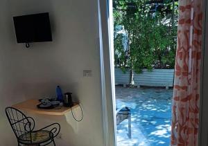 a room with a table and a television next to a window at B&b La Vigna in Furore