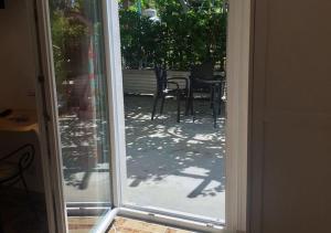 an open door to a patio with a table and chairs at B&b La Vigna in Furore