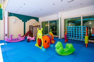 a childrens play room with various toys on the floor at Hotel Smeraldo in Cesenatico