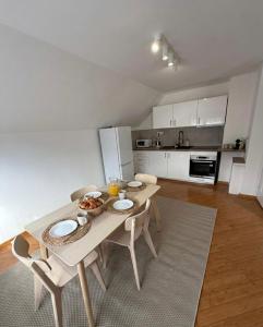 a kitchen with a table and chairs in a room at Cozy Apartment with Balcony in Ivanjica