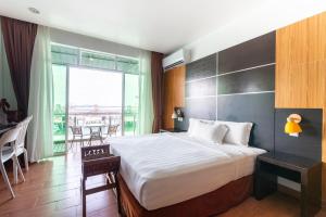 a hotel room with a bed and a balcony at Sipadan Inn 2 in Semporna