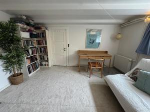 a living room with a table and a couch at Cozy and Spacious Guest Room, Virum in Virum