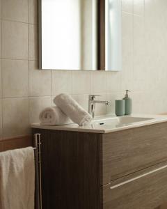 a bathroom with a sink and a mirror and towels at Suite 64 in Saviano +32 photos