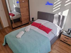 a bedroom with a bed with two towels on it at Apartament City Dream in Legnica