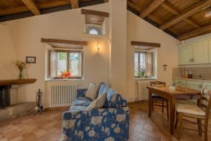 a living room with a blue couch and a table at Borgotufi Albergo Diffuso in Castel del Giudice
