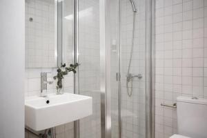 a white bathroom with a sink and a shower at Palacios Rooms in Valencia +45 photos