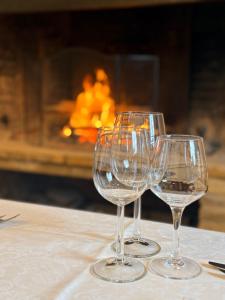 three wine glasses sitting on top of a table at Chateau De Latour in Latour
