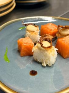 a blue plate with sushi on a table at Chateau De Latour in Latour +8 photos