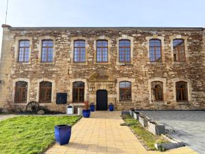 a large brick building with a black door at Chateau De Latour in Latour
