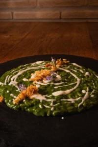 a plate of food with green sauce and toppings on it at Poggio dei cavalieri in Boccea