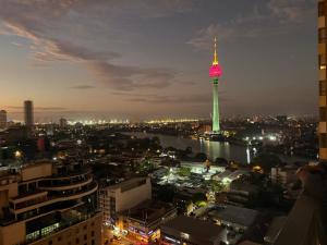 a view of a city at night with a tv tower at Tri-Zen Luxury Apartment Colombo, Tower 02, 20F, A2 in Colombo