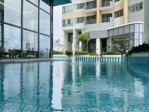 a swimming pool in front of a building at Tri-Zen Luxury Apartment Colombo, Tower 02, 20F, A2 in Colombo