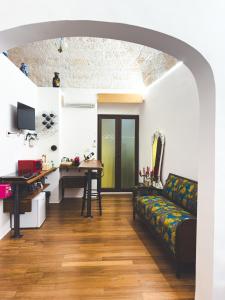 a living room with a couch and a desk at Corte Lirice Paradiso in Gioia del Colle