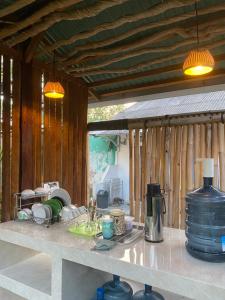 a kitchen counter with dishes on a counter top at Mango Room Mandalika in Kuta Lombok