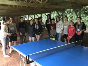 a group of people standing around a ping pong table at ZEcamping 3 étoiles chiens acceptés animations piscine chauffée in Grand-Laviers +41 photos