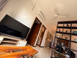 a living room with a large flat screen tv on a wall at Tri-Zen Luxury Apartment Colombo, Tower 02, 20F, A2 in Colombo