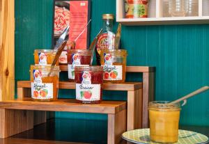 a shelf with jars of food and drinks on it at B&B HOTEL Lyon Nord 4 étoiles in Dardilly