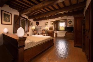 a bedroom with a bed and a television in it at Castello Di Petroia Dimora d'Epoca in Gubbio +53 photos