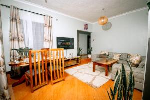 a living room with a couch and a table at Lasai casa in Arusha