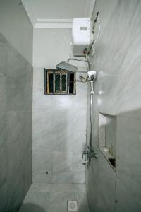 a bathroom with a shower with a window and a mirror at Lasai casa in Arusha +29 photos