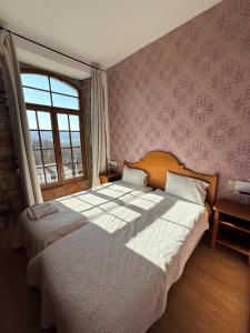 a bedroom with a large bed and a window at Chateau De Latour in Latour