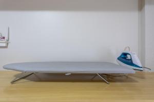 a bed sitting on top of a wooden floor at Flat - Excelente localização - Hotel Garvey in Brasília