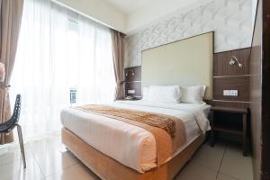 a bedroom with a large bed and a large window at Sipadan Inn 3 in Semporna