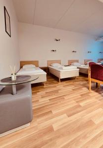 a room with beds and a table and chairs at THH Apartments in Tallinn