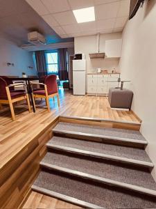 a room with a kitchen and a living room with stairs at THH Apartments in Tallinn