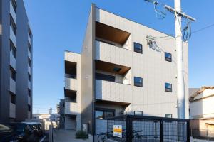 a building with balconies on the side of it at Bio Top Apartment Stay in Fukuoka