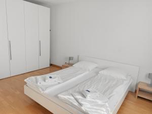 a white bed with two white towels on it at Cozy 1BR near lake with balcony - Mill 422 in Zurich