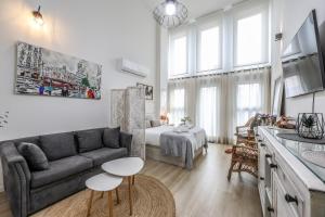 a living room with a couch and a table at Fancy Studio with Terrace & Pool - Madrid South in Villaverde +27 photos