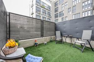 a small balcony with a patio with grass and chairs at Fancy Studio with Terrace & Pool - Madrid South in Villaverde