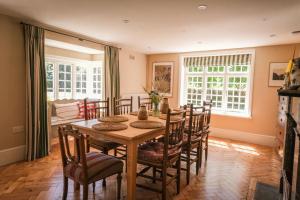 a dining room with a wooden table and chairs at Challens Yarde in Midhurst