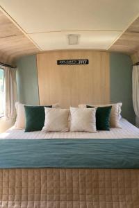 a large bed in the middle of a room at Refúgio Da Lua - Buss motorhome in Ametista do Sul
