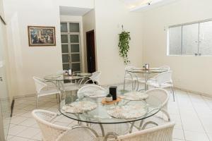 a group of tables and chairs in a room at San Felipe Hotel in Colinas do Tocantins